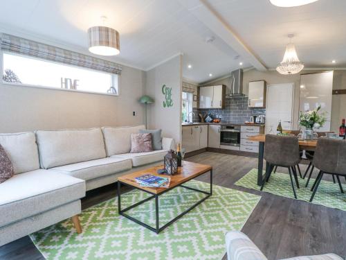 a living room with a couch and a table at Wurzburc in Swaffham