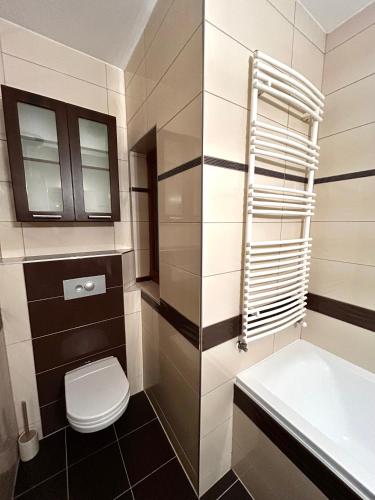 a bathroom with a toilet and a sink at Imperial Apartman in Győr