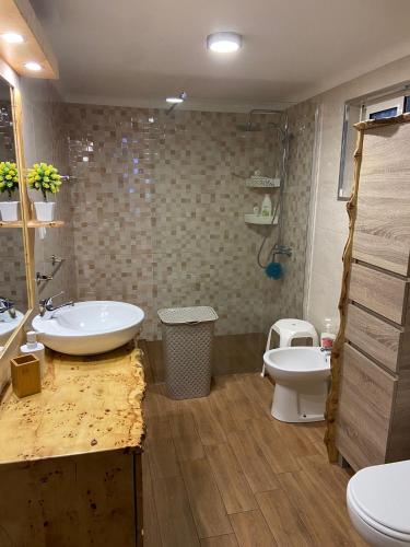 a bathroom with a sink and a toilet at Val's Place in Praia da Vitória