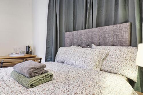 a bed with a blanket and pillows on it at Ivy on Sea Villa in Southend-on-Sea