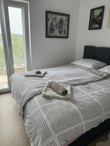 a bedroom with a bed with towels on it at Kuća za podmor Olea in Nečujam