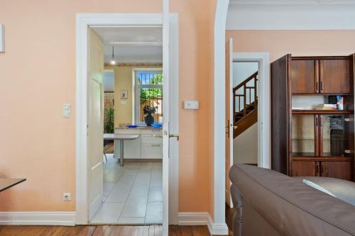a living room with a door leading to a kitchen at Cozy 3BR Townhome Walk to City Center & Park Free in Luxembourg