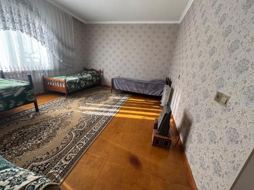 a room with two beds and a tv in it at Skyview in Qusar