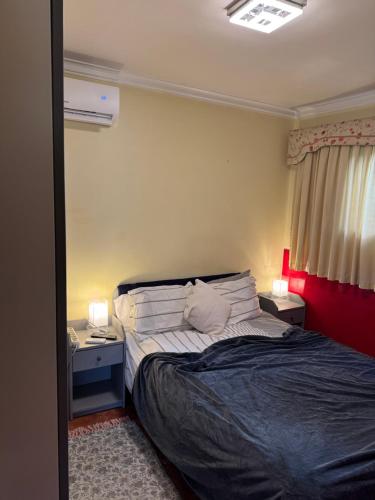 a bedroom with a bed with two night stands and two lamps at Casa Monsenhor in Braga