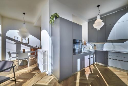 a kitchen with blue cabinets and a dining room at Apt In Villa Bianca in Lierna