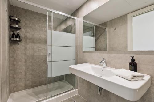 a bathroom with a sink and a shower at Ola Living Arc de Triomf in Barcelona