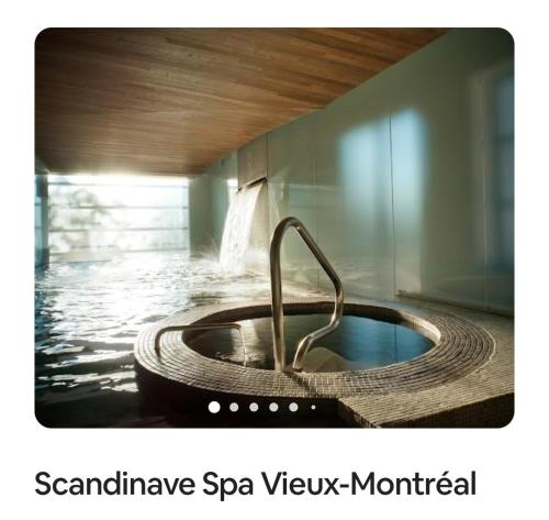 a bath tub with a water faucet in a room at Le Magnifique - Close by Downtown in Montréal