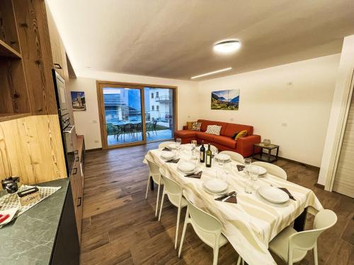 a dining room with a table and a couch at Holiday Home Guarnelle House 1 by Interhome in Bianzone