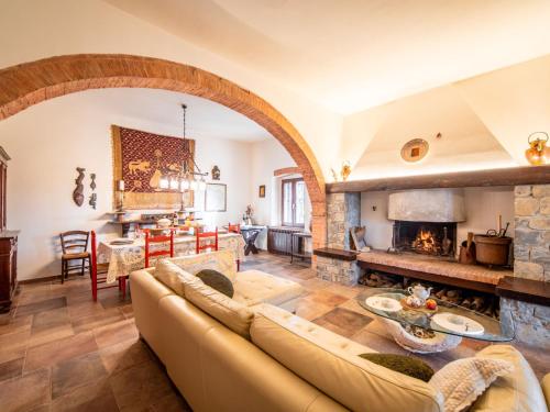 a living room with a couch and a fireplace at Holiday Home Villa Angiolino by Interhome in Poggibonsi