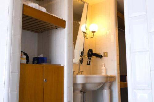 a bathroom with a sink and a mirror at The Cettia Istanbul in Istanbul