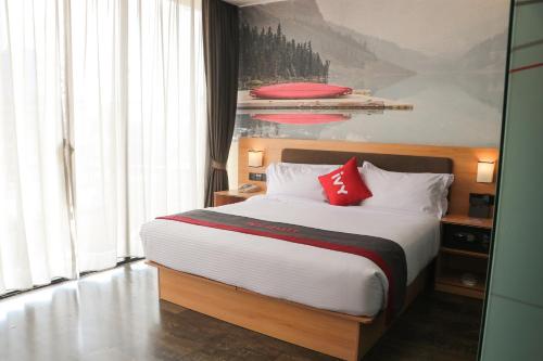 a bedroom with a large bed with red pillows at IVY Hotel Addis Ababa Airport branch in Addis Ababa