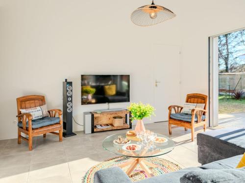 a living room with a fireplace and a tv at Holiday Home Domaine de Peyroutic by Interhome in Aureilhan