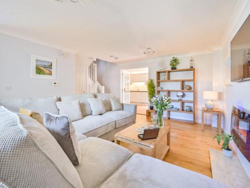 a living room with a couch and a table at Holiday Home Sea Compass by Interhome in Charlestown