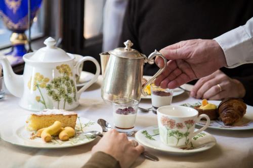 a group of people sitting at a table with tea at Hotel Flora in Venice