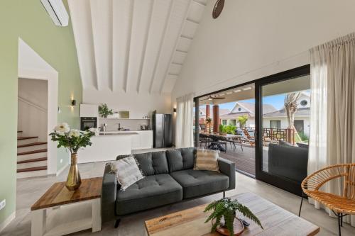a living room with a couch and a table at NEW! The Jazmyn at Blue Bay Golf & Beach Resort in Sint Michiel
