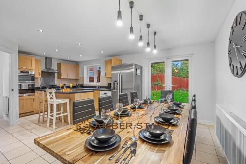 レディングにあるSpacious 5 Bed House in Reading by Amber Stays, Perfect for Business & Contractors, Sleeps 12のキッチン(食器、調理器具、テーブル付)