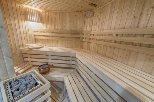 a large wooden sauna with a bench in it at Hotel Lazur SPA & Conference in Kalisz