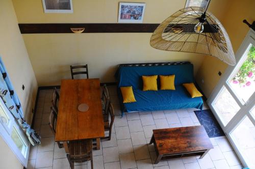 un salon avec un canapé bleu et une table dans l'établissement Black Mountain Village, à Cuxac-Cabardès