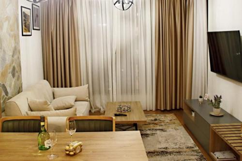 a living room with a table and a couch at Dream residence Lux apartment Zlatibor in Zlatibor