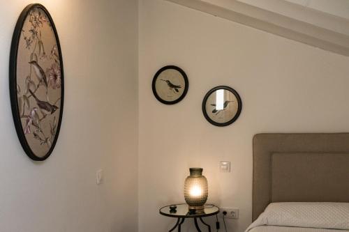 a bedroom with three clocks on the wall and a table at Casa Bederna in Comillas