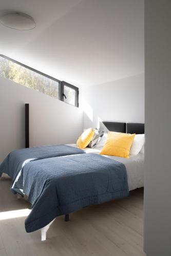 a bedroom with two beds and a large window at El Corral de Jirueque in Jirueque