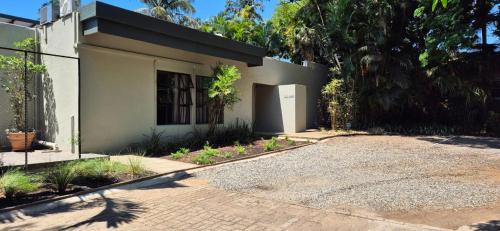 a house with a driveway in front of it at Fairway Lodge in Pongola