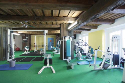 a gym with several treadmills and exercise machines at Hotel Flattacher Hof in Flattach