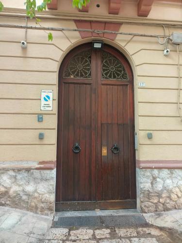 a wooden door on the side of a building at B&B IL POETA in Palermo