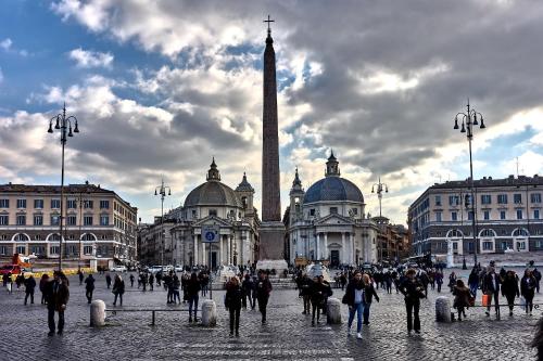 a group of people walking in front of a building at The Club Navona in Rome