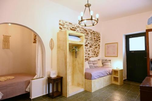 a bedroom with a bed in a room with a window at House on the island in Kithnos