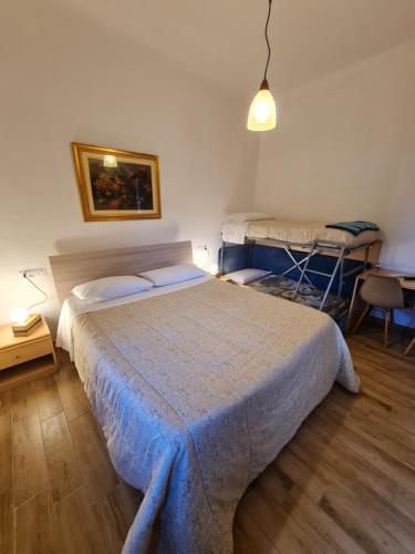 a bedroom with a bed and a table with a lamp at Albergo Genio in Portovenere