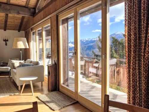 a living room with a large window with a view at Chalet L'Alpage by Interhome in Ovronnaz