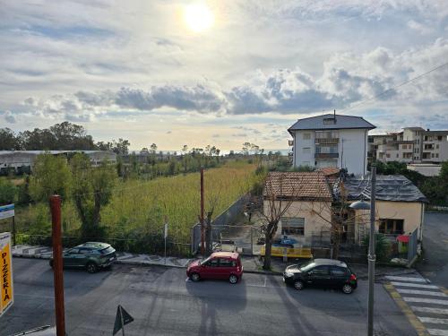 a parking lot with cars parked in front of a building at Max Guest House in Praia a Mare