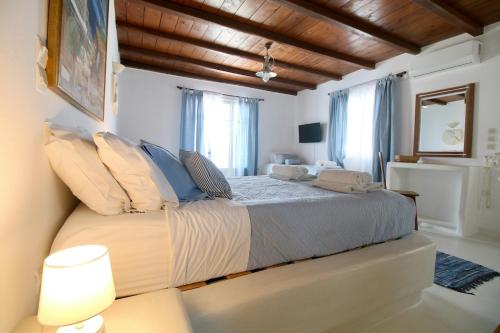 a bedroom with a large bed in a room at Blue Bay Heliolithos in Parikia