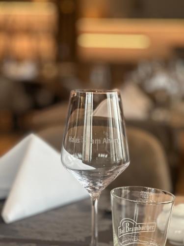 a glass of wine sitting next to a glass of water at Hotel Haus am Ahorn in Schöneck