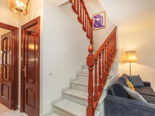a staircase in a house with a blue couch at Holiday Home Jorge Comin by Interhome in Benicàssim