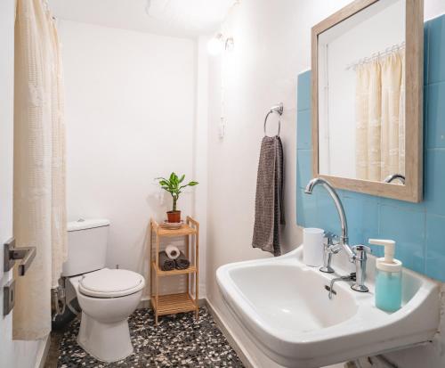 a bathroom with a sink and a toilet and a mirror at Apartment 105 sq.m. near center in Patra