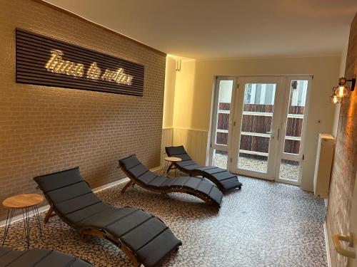 a waiting room with three chairs and a window at Hotel Haus am Ahorn in Schöneck