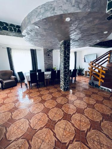 a room with a table and chairs and a stone ceiling at Transylvania Hut in Moieciu de Sus