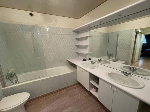 une salle de bain avec deux lavabos et une baignoire et des toilettes dans l'établissement Triplex spacieux pour 12 pers avec 4 ch - Cauterets - FR-1-812-7, à Cauterets