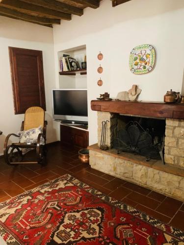 a living room with a fireplace and a flat screen tv at Country Home Marsciano in Marsciano