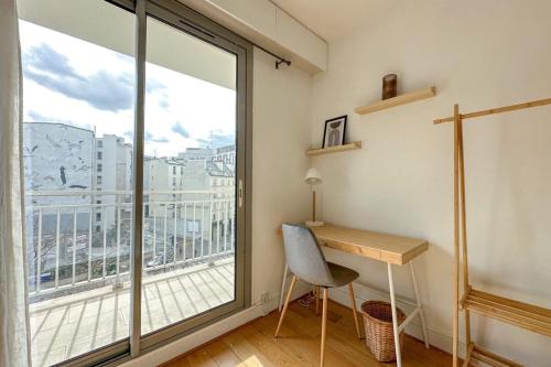 a room with a desk and a large window at Flexliving - room - Ternes in Paris