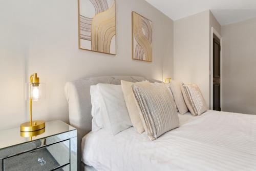 a bedroom with a bed with white sheets and pillows at WhiskAwayStays - Victoria House - Apartment 2 in Worcester