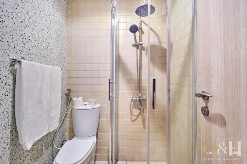 a bathroom with a toilet and a glass shower at Stunning views of Dubai Sea, Dubai Eye & JBRWalk in Dubai