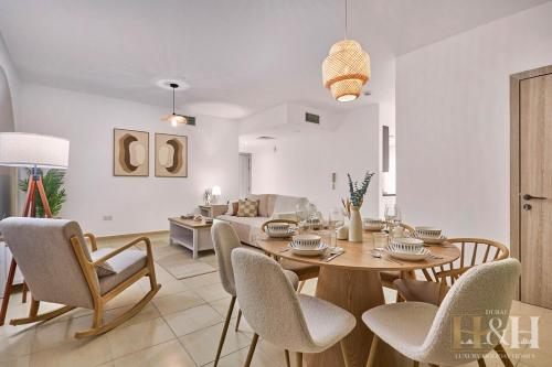 a dining room and living room with a table and chairs at Stunning views of Dubai Sea, Dubai Eye & JBRWalk in Dubai