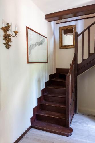 a staircase in a house with a picture on the wall at Villa Sarchi in Grantola