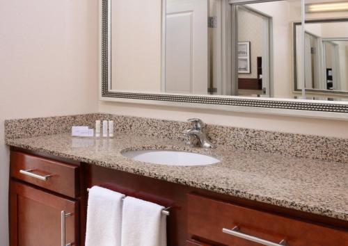 a bathroom with a sink and a mirror at Residence Inn by Marriott Dallas Plano The Colony in The Colony