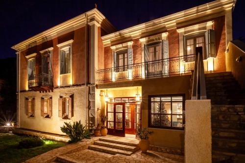 a large house at night with its lights on at Archontiko Parnassus Dadi in Amfiklia