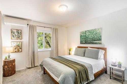 a bedroom with a bed and a window at Sierra Vista Lookout Lodge for 8 people with Hot tub, deck and trail to waterfalls in North Fork