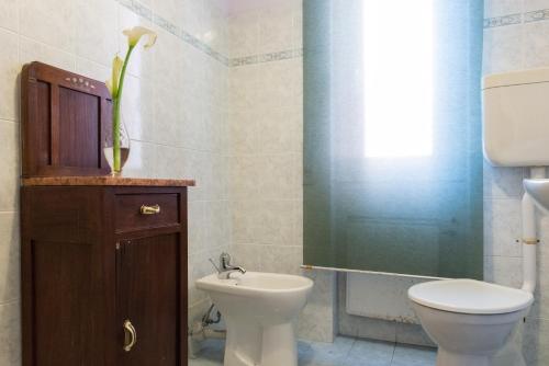 a bathroom with a toilet and a sink at Hotel Eden in Arenzano